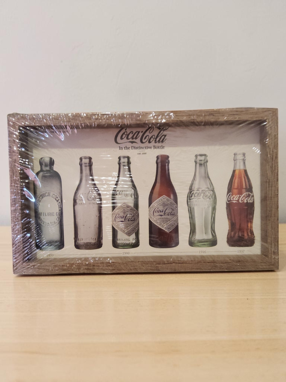 10 / $10 Coca-Cola Vintage Bottle Evolution Wall Art - Brown Wood Frame